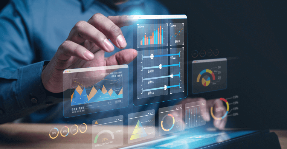 Elevating Mortgage Bfsi Operations: How Azure Cloud Solutions Drive Efficiency And Innovation 2 A professional analyzing financial data on a transparent futuristic touchscreen device, displaying interactive charts and graphs that indicate business analytics and performance metrics.