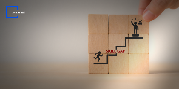 Hand stacking wooden blocks illustrating a 'SKILL GAP' with figures climbing steps, highlighting career development, with 'Compunnel' logo