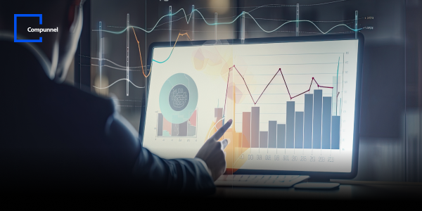 A person interacts with a large computer monitor displaying various data visualizations, including bar charts, line graphs, and pie charts. The graphs show complex data trends and analysis. The Compunnel logo is visible in the top left corner, indicating the context of data-driven insights and business intelligence.