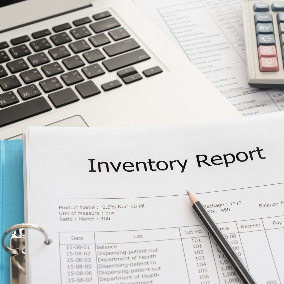 An inventory report document on a desk, accompanied by a pencil, calculator, and laptop keyboard, representing business and financial analysis.